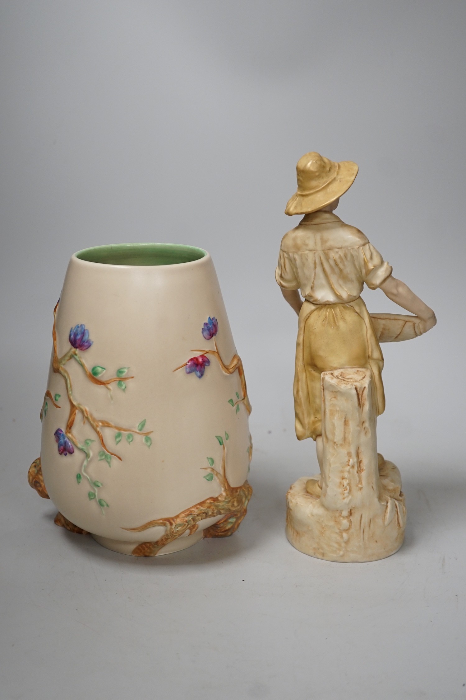 A Royal Dux figure of a water carrier and a Clarice Cliff for Newport Pottery vase. Tallest 27cm